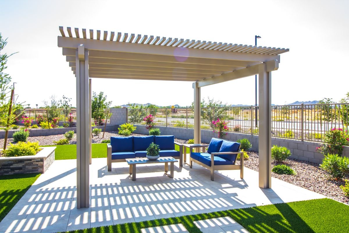  A patio featuring a pergola and blue furniture, showcasing a stylish outdoor space for relaxation and furniture service.